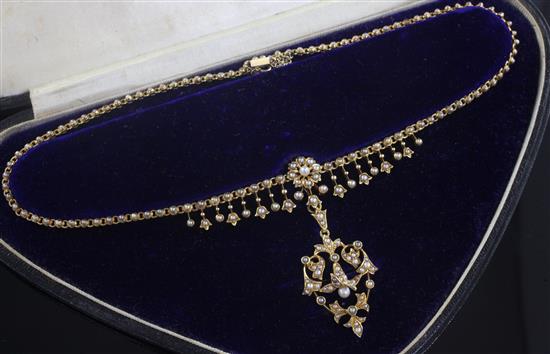 A late Victorian 15ct gold and seed pearl set pendant necklace, chain 38cm.